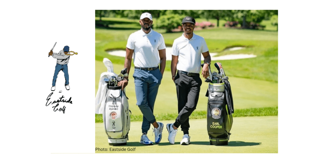Two golfers pose on the golf course next to their black and white golf bags.
