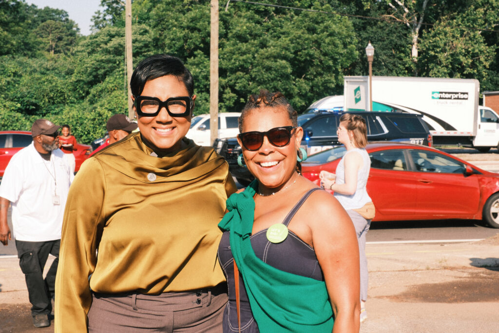 Two women pose for the camera with big smiles.